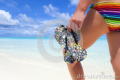 Woman with flip flops on a beach
