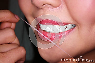 Woman flossing her teeth