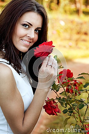 http://thumbs.dreamstime.com/x/woman-flower-garden-smelling-red-roses-13755220.jpg