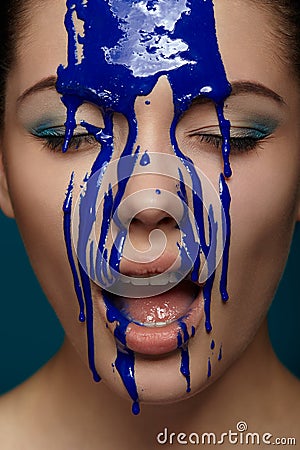 Woman with flowing blue paint