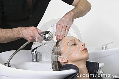 Woman Getting Hair Wash From Hairdresser In Salon