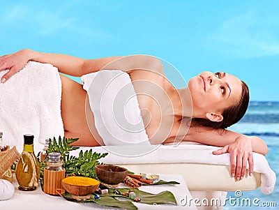 Woman getting spa treatment outdoor.