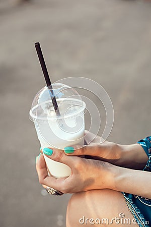 Woman with glasses drinking milkshake