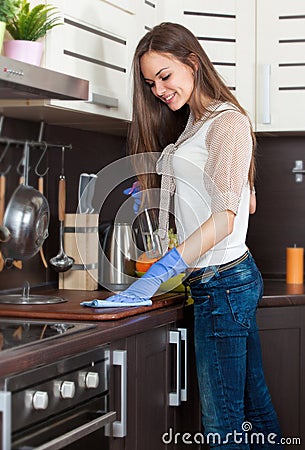 Woman with gloves cleaning kitchen