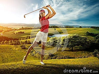 Woman golfer hitting the ball on the background scenery beautiful