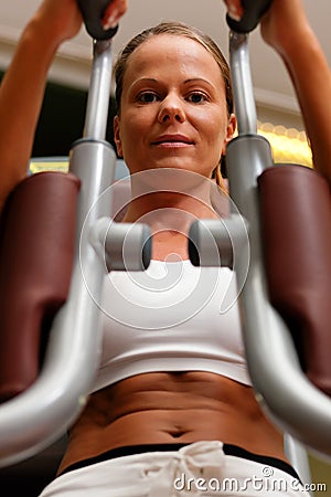 Woman in gym on machine exercising