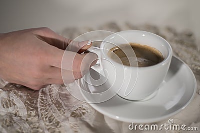 Woman hand with cup of coffee