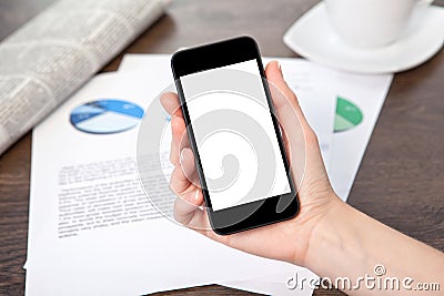 Woman hand holding a phone on the table with graphics