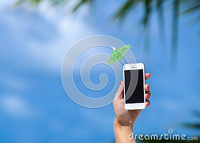 Woman hand showing mobile phone and cocktail umbrella