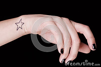 Woman hand with star tatoo