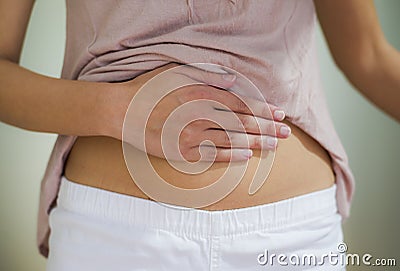 Woman with hand on stomach