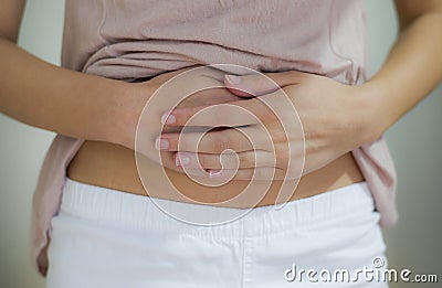 Woman with hand on stomach
