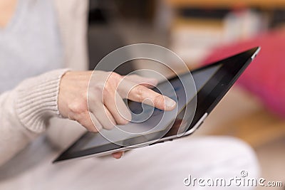 Woman hand touching screen on digital tablet.