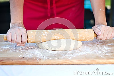 Woman hands rolling dough