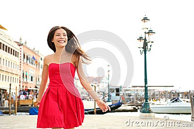 Woman happy running in summer dress, Venice, Italy