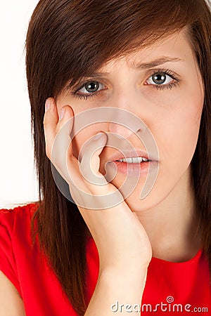 The woman has got toothache and is holding her cheek