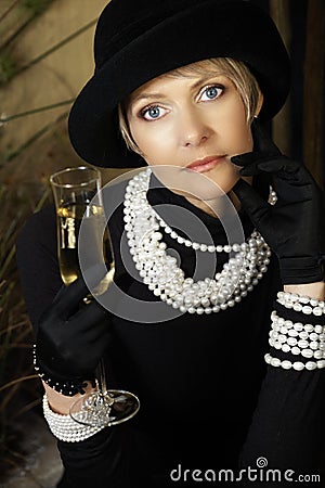Woman in hat, pearls and champagne
