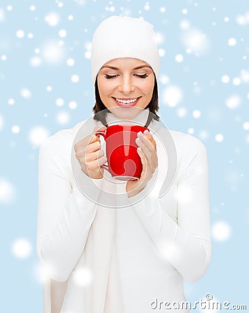 Woman in hat with red tea or coffee mug