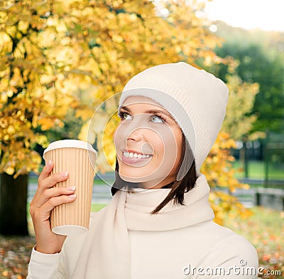 Woman in hat with takeaway tea or coffee cup