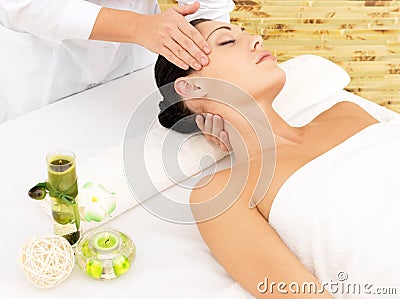 Woman having massage of face in spa salon