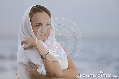 Woman with head scarf on the beach