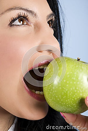 Woman with healthy teeth bite an apple