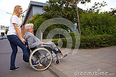 Woman helping wheelchair user