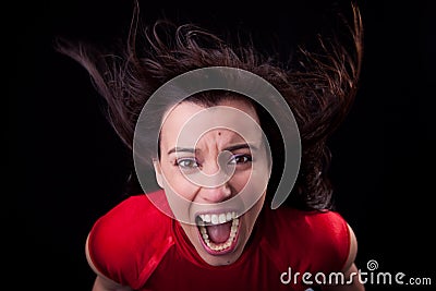 Woman with her hair in wind,screaming in fury