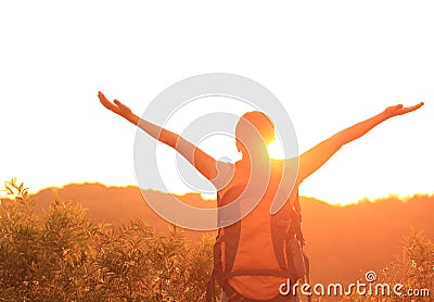 Woman hiker raised arms mountain top