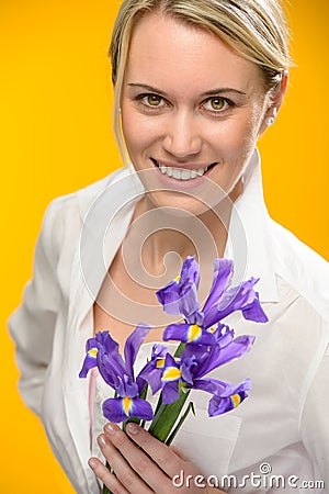 Woman hold one spring iris flower smiling