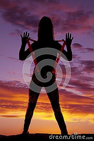 Woman hold up suspenders silhouette