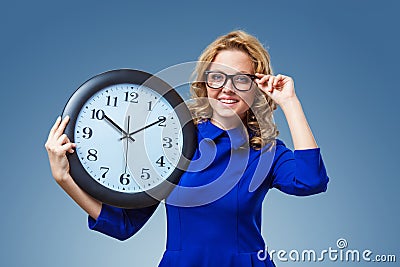 Woman holding big clock