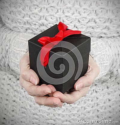 Woman holding black gift box