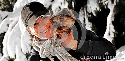 Woman holding a dog in the snow