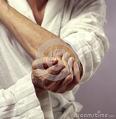 Woman holding elbow in pain