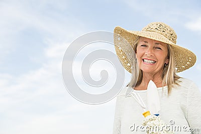 Woman Holding Gardening Equipment Against Sky