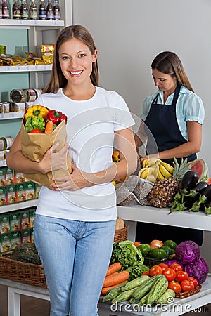 Woman Holding Grocery Bag At Supermarket