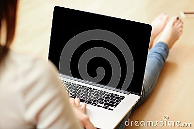 Woman holding laptop with blank screen