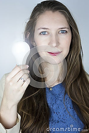 Woman holding lit light bulb