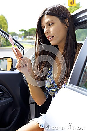 Woman holding money at gas station