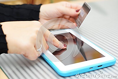 Woman holding tablet pc and credit card , on line Shopping Conce