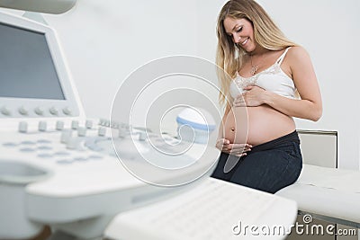 Woman Holding Tummy By Ultrasound Machine