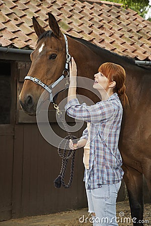 Woman With Horse Outside Stable