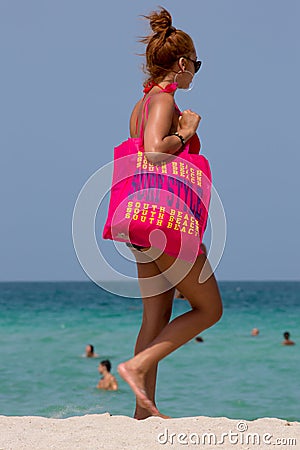 Woman with huge pink Bag surf style in miami beach