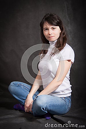 Woman in jeans sitting on the floor