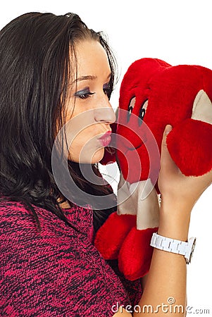 Woman kissing a heart toy