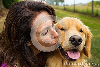 Woman kissing her dog