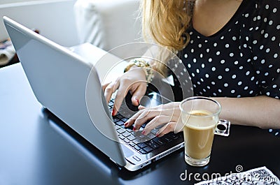 Woman with laptop and coffee