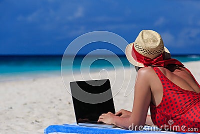 Woman with laptop on tropical vacation