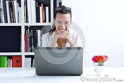 Woman with laptop working at home
